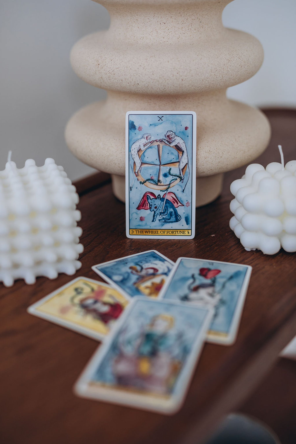 Tarot cards with sculptural cream candles